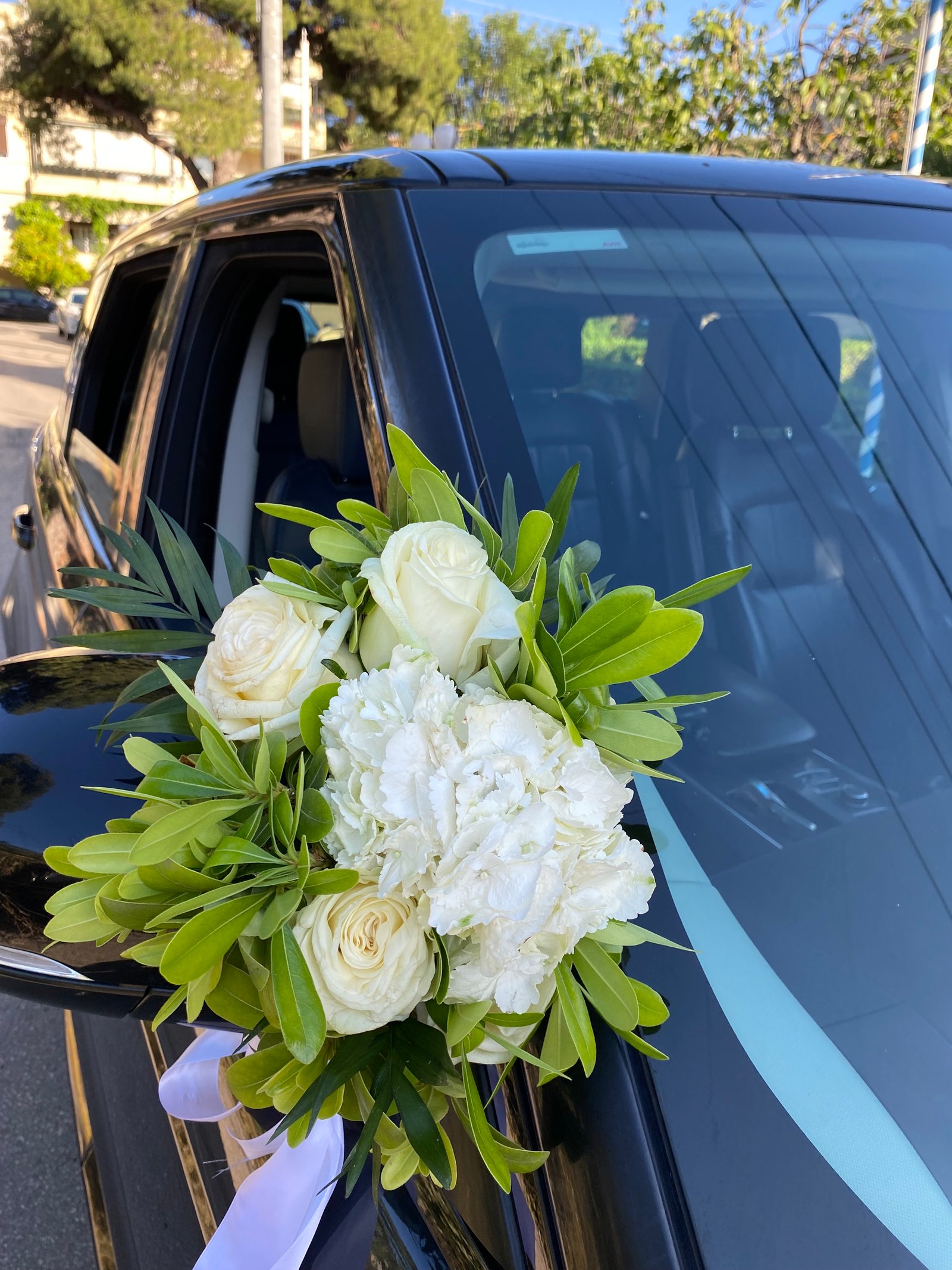 White floral arrangement for the wedding car