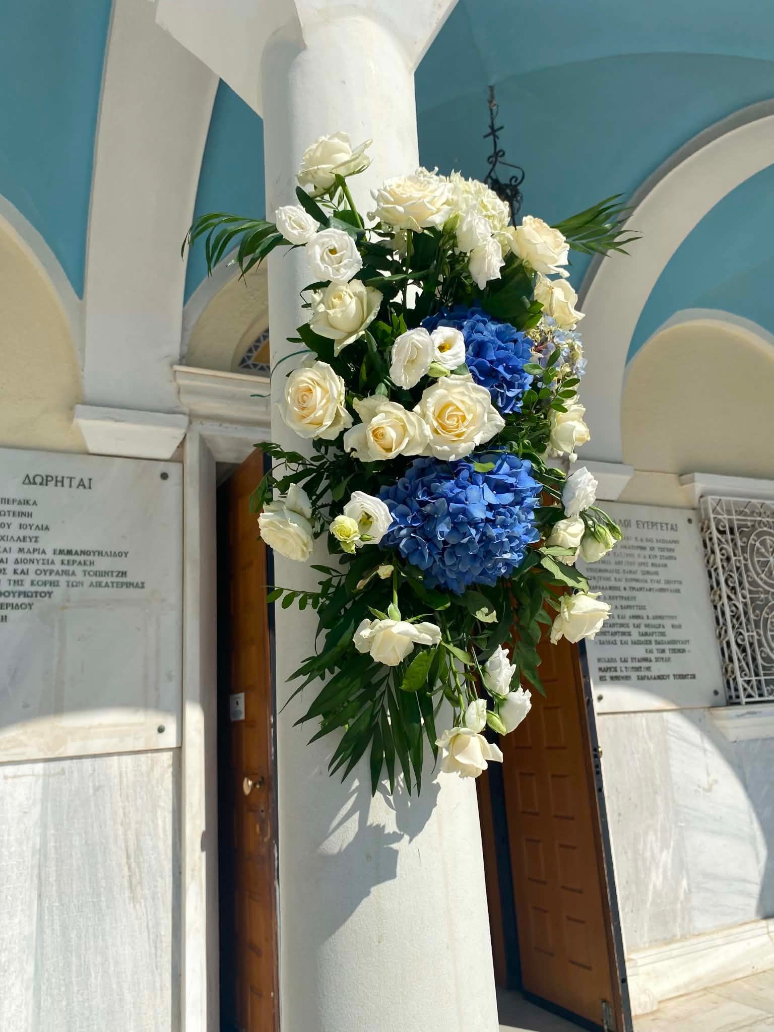 Church column styling with white and blue flowers