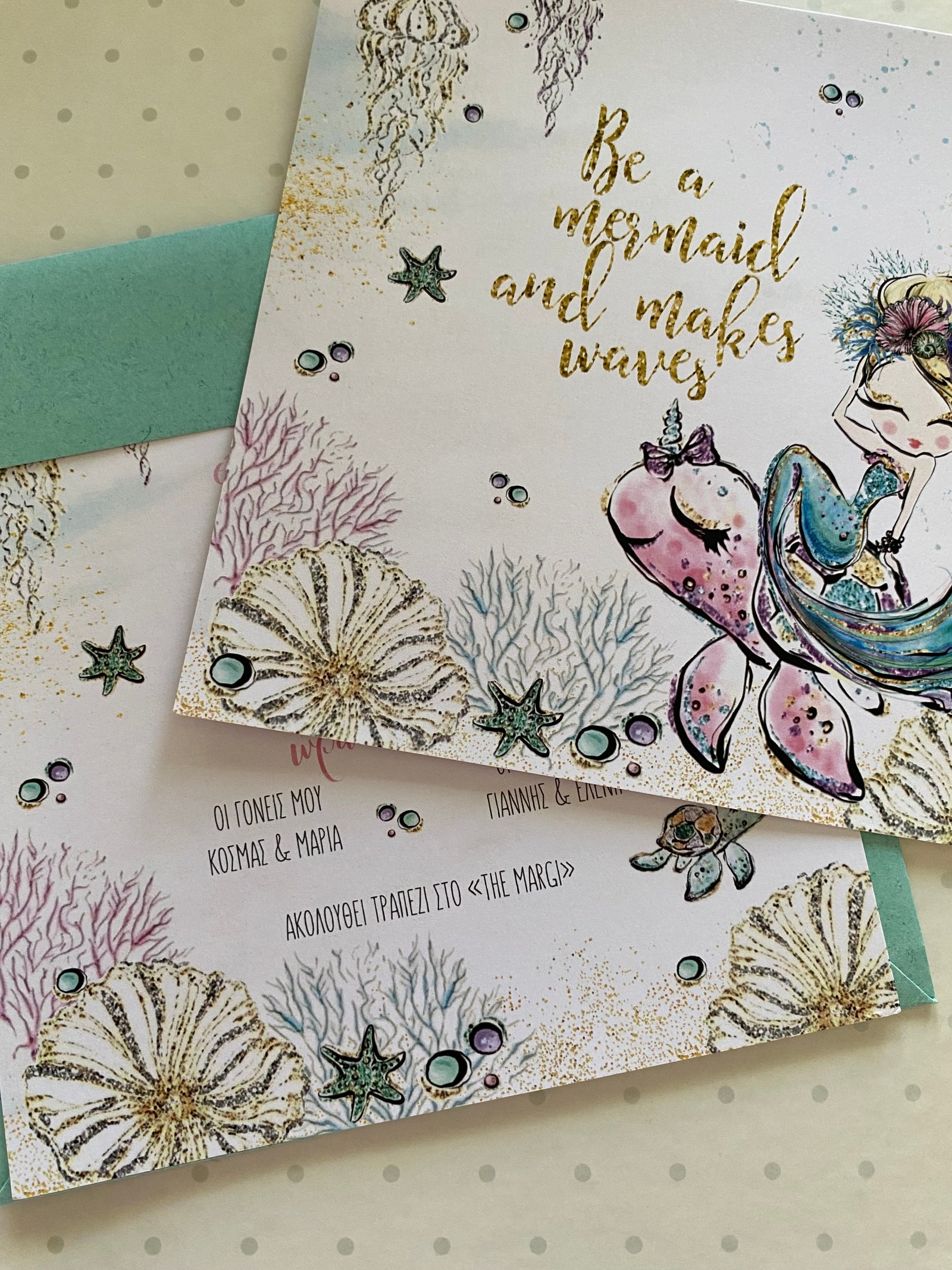 Open christening invitation with a perfume theme